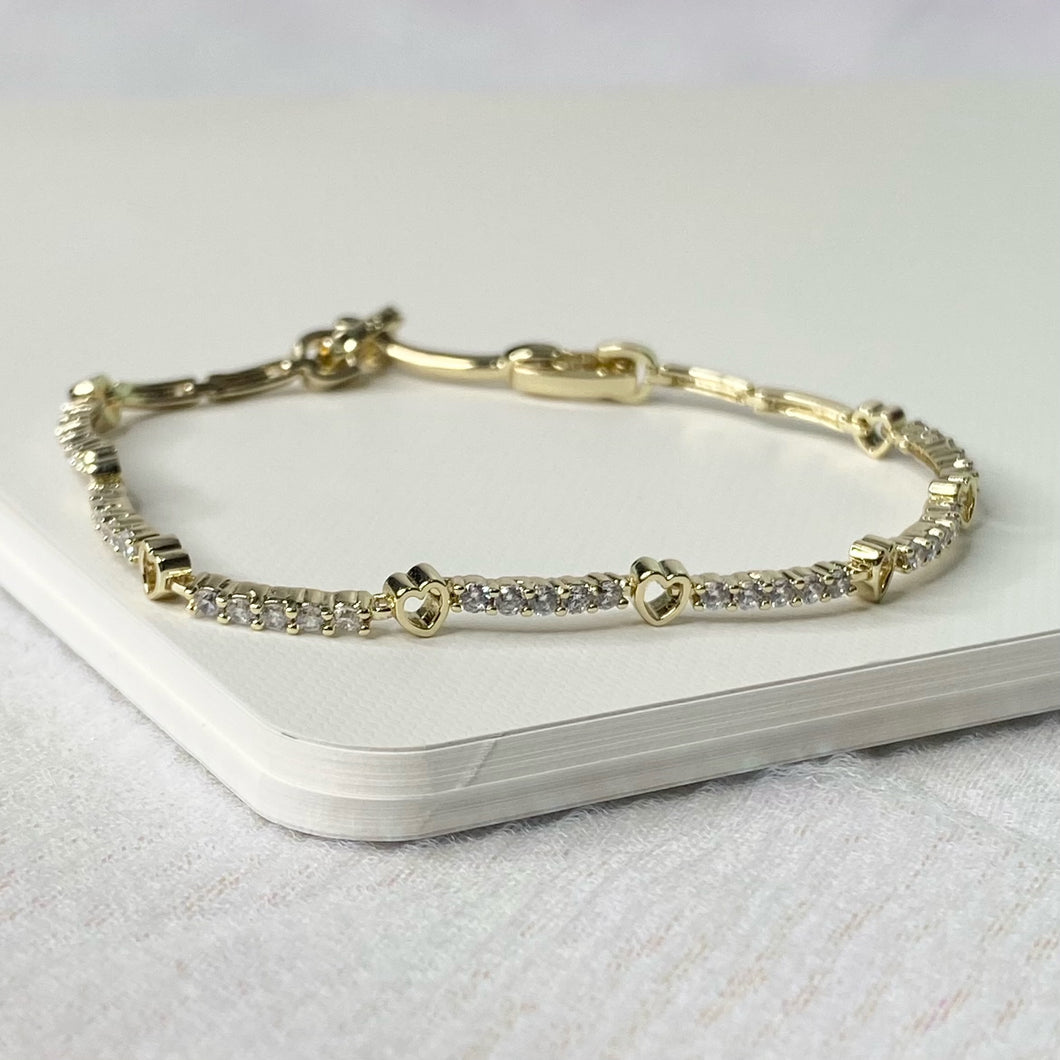 Gold Necklace with hearts and rhinestones.