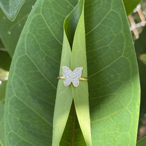 Rhinestone butterfly ring on a leaf.