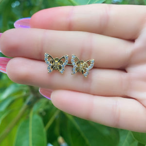 hand hold a pair of rhinestone butterfly studs